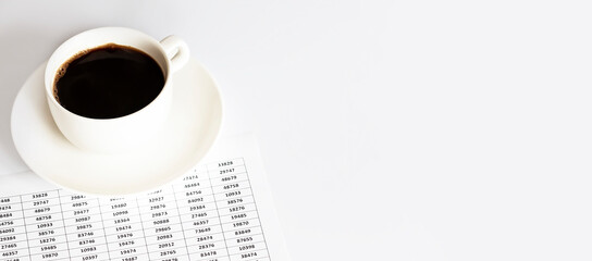 A white Cup of coffee next to the documents. A break with a Cup of coffee at work