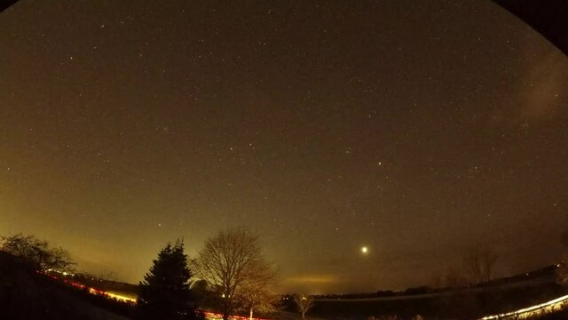 Nightlapse of the stars and clouds. 
Lights from cars driving by.