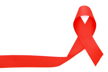 Red ribbon on a white background. The concept of the world day of fight against AIDS. The concept of the world day of fight against cancer. The view from the top. Flatly. Copy space.