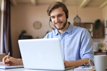 Freelance operator talking with headsets and consulting clients from home office.