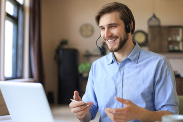 Freelance operator talking with headsets and consulting clients from home office.