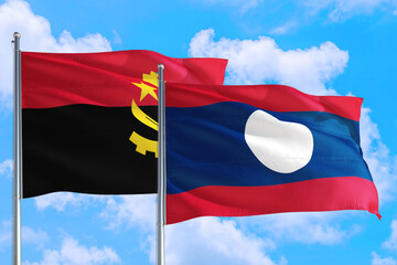Laos and Angola national flag waving in the windy deep blue sky. Diplomacy and international relations concept.