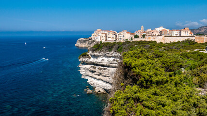Fototapeta na wymiar Corsica Bonifacio white cliff with citadel old town facing the Mediterranean Sea during sunny day