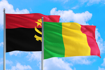 Mali and Angola national flag waving in the windy deep blue sky. Diplomacy and international relations concept.