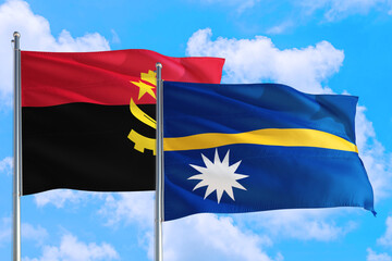 Nauru and Angola national flag waving in the windy deep blue sky. Diplomacy and international relations concept.