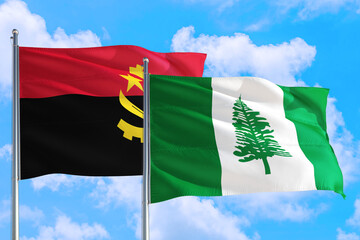 Norfolk Island and Angola national flag waving in the windy deep blue sky. Diplomacy and international relations concept.