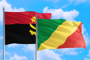 Republic Of The Congo and Angola national flag waving in the windy deep blue sky. Diplomacy and international relations concept.