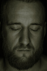Studio session with one muscular man in low-key light conditions