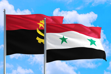 Syria and Angola national flag waving in the windy deep blue sky. Diplomacy and international relations concept.