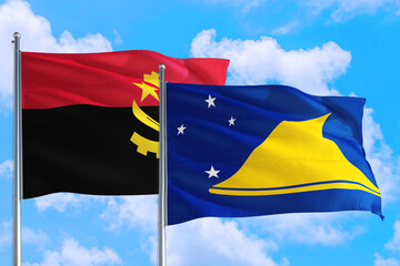 Tokelau and Angola national flag waving in the windy deep blue sky. Diplomacy and international relations concept.