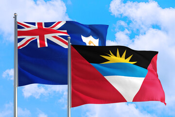 Antigua and Barbuda and Anguilla national flag waving in the windy deep blue sky. Diplomacy and international relations concept.