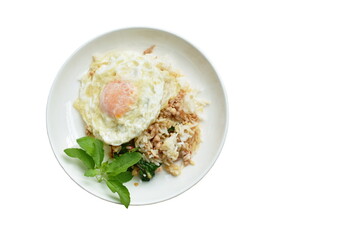 spicy fried choppork with basilleaf and chili topping egg on rice in dish