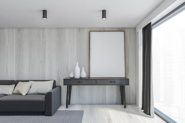 Living room with a blank frame, light grey room with a grey sofa and mockup