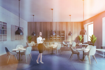 Woman in white and wooden cafe interior
