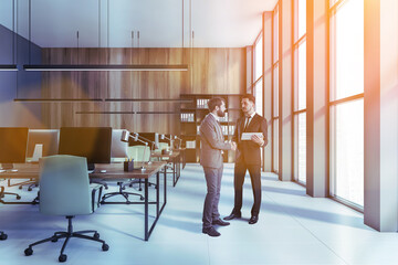Two men in wooden and gray open space office