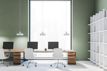 Green wall office with wooden tables and window, white chairs and bookshelf