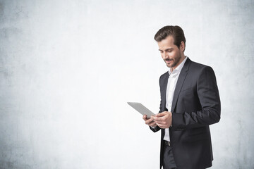 Bearded young businessman with tablet, mock up