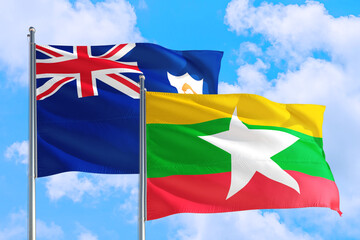 Myanmar and Anguilla national flag waving in the windy deep blue sky. Diplomacy and international relations concept.