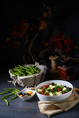 Spicy green bean salad with olives, feta cheese and dried tomatoes