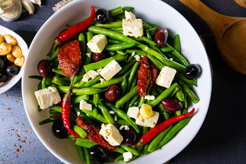 Spicy green bean salad with olives, feta cheese and dried tomatoes