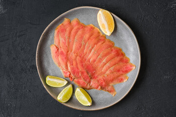 Top view of smoked thin slices of salmon fillet