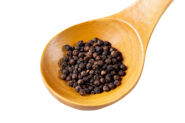 Black peppercorns lie in a varnished wooden spoon. Isolated on white background. Close-up.