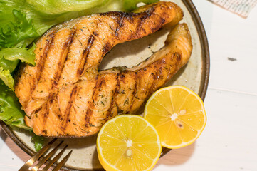 Homemade organic salmon steak with lettuce leaves