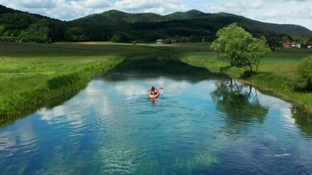 Adventurer travels down Gacka river by Kayak, Lika, Croatia