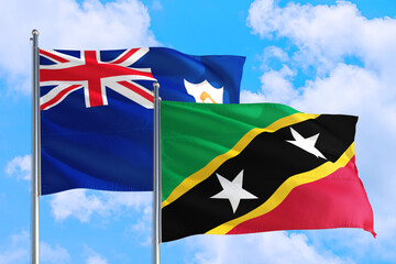 Saint Kitts And Nevis and Anguilla national flag waving in the windy deep blue sky. Diplomacy and international relations concept.