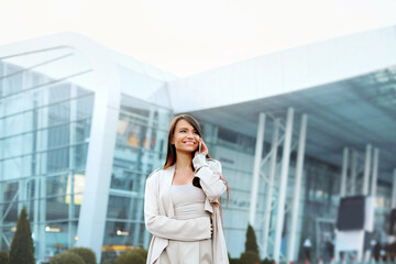 Fototapeta premium Beautiful Business women talking by smartphone at street. Girl have conversation speaking by mobile