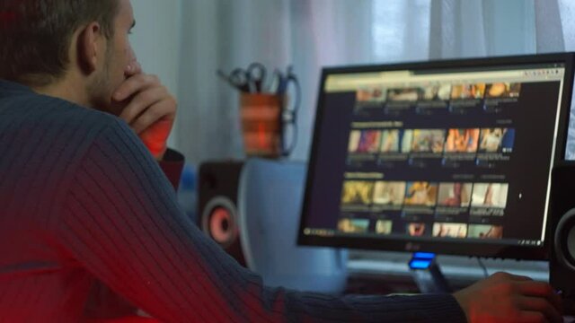 the guy is watching a video on the computer