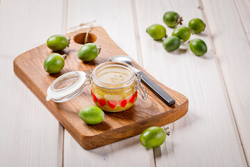Still life with feijoa fruits and feijoa jam in the jar