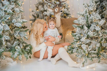 Obraz na płótnie Canvas Winter holiday concept. Inspiration and fairy time. Mom and little girl near Christmas tree at holydays. Pretty nice cozy holiday days, magical Christmas time