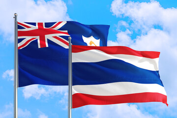 Thailand and Anguilla national flag waving in the windy deep blue sky. Diplomacy and international relations concept.