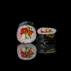 sushi on a black plate