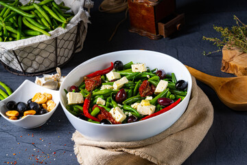 Spicy green bean salad with olives, feta cheese and dried tomatoes