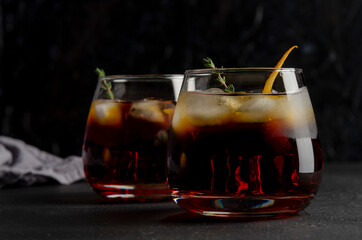 Two glasses of boulevardie cocktail on the black