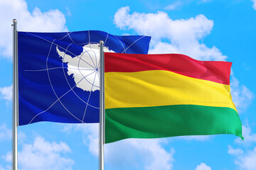 Bolivia and Antarctica national flag waving in the windy deep blue sky. Diplomacy and international relations concept.