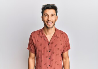 Young handsome man wearing casual summer clothes with a happy and cool smile on face. lucky person.