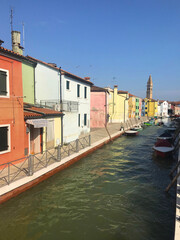 Fototapeta na wymiar Burano island canal and colorful houses with boats in Venice Italy