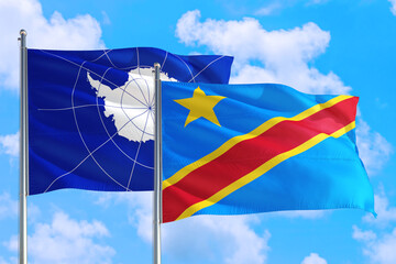 Congo and Antarctica national flag waving in the windy deep blue sky. Diplomacy and international relations concept.