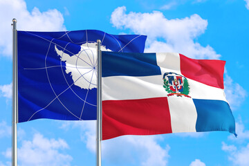 Dominican Republic and Antarctica national flag waving in the windy deep blue sky. Diplomacy and international relations concept.