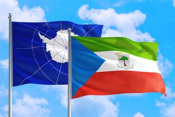 Equatorial Guinea and Antarctica national flag waving in the windy deep blue sky. Diplomacy and international relations concept.