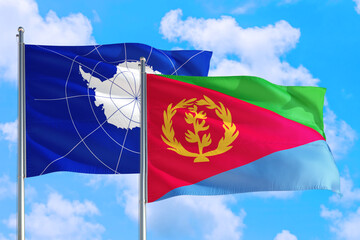 Eritrea and Antarctica national flag waving in the windy deep blue sky. Diplomacy and international relations concept.