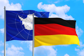 Germany and Antarctica national flag waving in the windy deep blue sky. Diplomacy and international relations concept.