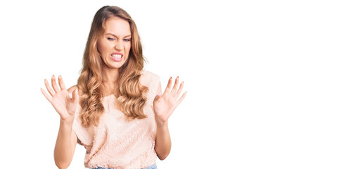 Fototapeta na wymiar Young beautiful caucasian woman with blond hair wearing casual clothes disgusted expression, displeased and fearful doing disgust face because aversion reaction.