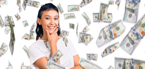 Young woman wearing casual clothes looking confident at the camera smiling with crossed arms and hand raised on chin. thinking positive.