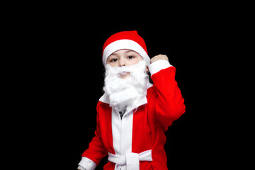 a five-year-old boy in a funny Santa Claus costume stands with a package of gifts. on a black isolated background