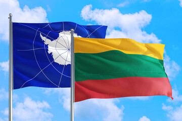 Lithuania and Antarctica national flag waving in the windy deep blue sky. Diplomacy and international relations concept.