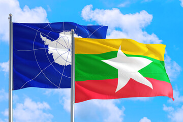 Myanmar and Antarctica national flag waving in the windy deep blue sky. Diplomacy and international relations concept.